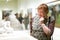 Portrait of retiree woman attentively looking at sculptures