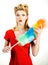 Portrait of a retro woman as a housemaid or professional cleaner standing with cleaning tools. Funny female housekeeper