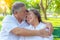 Portrait romantic older couple. Attractive handsome older husband embracing and kissing his older wife with love. Grandfather and