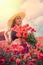 portrait of rpetty ukrainian woman in black top and hat with big bouquet of poppies in field