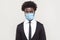 Portrait of sad alone young handsome worker man in black suit with surgical medical mask standing and looking at camera with tired