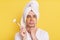 Portrait of sad Caucasian man wrapped towel on head doing morning cosmetology procedures, standing with pout lips, posing with