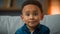 Portrait sad cute African American ethnic multiracial multiethnic child orphan small boy pupil son baby toddler serious