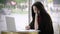 Portrait of sad girl looking laptop and signed document. Worried business woman face looking at notebook in cafeteria