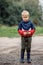 Portrait of a sad lonely boy in bad weather in autumn. The end of summer fun. Dirt and humidity outdoors there is no activity for