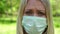 Portrait of a sad woman in a medical mask. Unhappy girl in a medical protective mask.