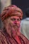 Portrait of a Sadhu Baba with colourful Face at Nandgaon Temple during Holi Festival,Uttarpradesh,India