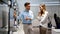 Portrait of salesman helping to woman to buy a new digital device in tech shop