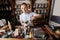 Portrait of salesman scooping tea from container at store