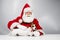 Portrait of santa claus and dog jack russell terrier in rudolf reindeer ears on a white background.