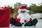 Portrait of Santa Claus sitting in a chair with his boots on the table with serious expression