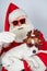 Portrait of santa claus in sunglasses and dog jack russell terrier in rudolf reindeer ears on a white background.