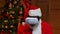 Portrait Santa Claus wearing virtual reality goggles with wow surprised expression on his face. Old man with beard in