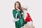 Portrait of Santa touching woman inappropriately against gray background