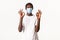 Portrait of satisfied african-american handsome guy in medical mask and beanie, staying protected during covid-19