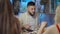 Portrait of satisfied handsome Caucasian young man tasting delicious food in restaurant sitting at table with friends