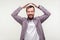 Portrait of satisfied happy bearded man making house symbol, roof gesture over head and smiling. white background