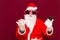 Portrait of satisfied santa claus use cell phone what happened. reading news isolated over red background