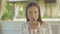 Portrait of satisfied woman eating tasty pie in outdoor cafe. Young brunette confident client enjoying meal in