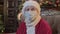 Portrait Satna Claus in medical protective mask from coronavirus pandemic looks at camera operator sitting in chair in