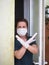 Portrait of scared women showing sign no, crossing arms, keeping distance, wearing antibacterial mask and gloves, looking directly
