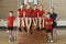 Portrait Of School Gym Team Sitting On Vaulting Horse