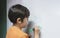 Portrait school kid drawing cartoon tank on white board, Child boy holding colour pen write on board, Home schooling, Education