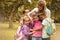 Portrait of school kids hugging teacher.