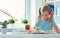 Portrait of schoolgirl at classroom writing at the table