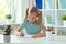 Portrait of schoolgirl at classroom writing at the table