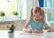 Portrait of schoolgirl at classroom writing at the table