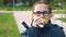 Portrait of a schoolgirl with glasses eating a hamburger.