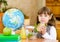 Portrait schoolgirl looking at camera while having lunch during