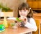 Portrait schoolgirl looking at camera while having lunch during