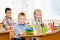 Portrait of schoolkids looking at camera at workplace