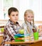 Portrait of schoolkids looking at camera at workplace