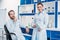 portrait of scientific researchers in lab coats with digital tablet