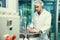 Portrait of a scientist, apothecary extracting cannabis oil in laboratory.