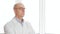 Portrait scientist bald man in glasses and white coat looking away on white window background. Bio engineer in white