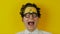 Portrait of screaming funny curly guy, positive crazy human emotion, on yellow wall background