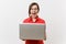 Portrait of screaming young business teacher woman user in red shirt, glasses working typing on laptop pc computer