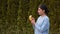 Portrait seductive attractive young woman with dark hair and red lips in blue jacket peeling banana and biting it