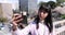 A portrait of selfie by Japanese woman behind cherry blossom