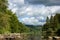 A portrait of the semois river in the vresse sur semois region in the Ardennes in Belgium. The river is surounded by hills and a