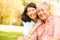 Portrait Of Senior Asian Couple Sitting In Park Together