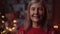 Portrait of the Senior Attractive Lady Looking at the Camera when Her Friends Having Fun on the Background. New Year