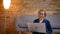 Portrait of senior caucasian lady sitting on floor and working with laptop with positive laughter in cozy home