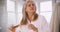 Portrait of senior Caucasian woman combing healthy hair