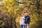 A portrait of a senior couple standing in an autumn nature. Copy space.