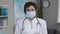 Portrait of Senior Family Medical Doctor in Face Mask. Successful Physician in White Lab Coat Looks at the Camera in